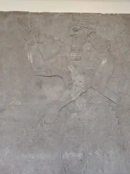 Relief, winged man holding solar discs, located at the Pergamon museum